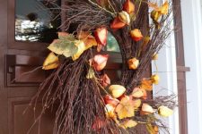 a beautiful fall twig wreath with dried seed pods and fall leaves is a stylish and bright solution for the fall