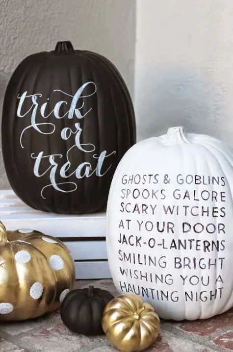 a black and a white pumpkin decorated with a black and white sharpie - with some words - look nice and quite modern at the same time