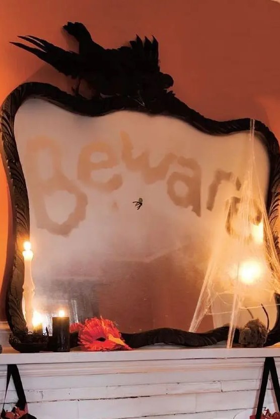 a black frame Halloween mirror with a words, some realistic blackbirds on top and some spiderweb is a cool idea