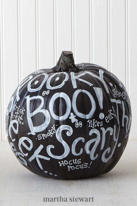 a black pumpkin decorated with words, with a white sharpie, looks super cool and bold for Halloween