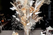 a boho centerpiece of dried blooms, bunny tails, dried grasses is a very bold idea for fall or Thanksgiving decor