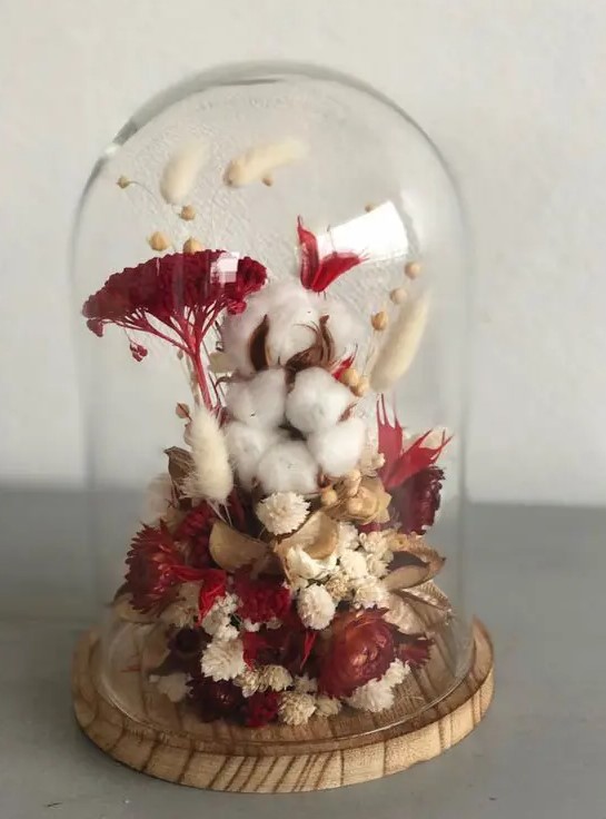 a bold fall flower dome with cotton, burgundy blooms and white dried ones and berries and grasses is very cool