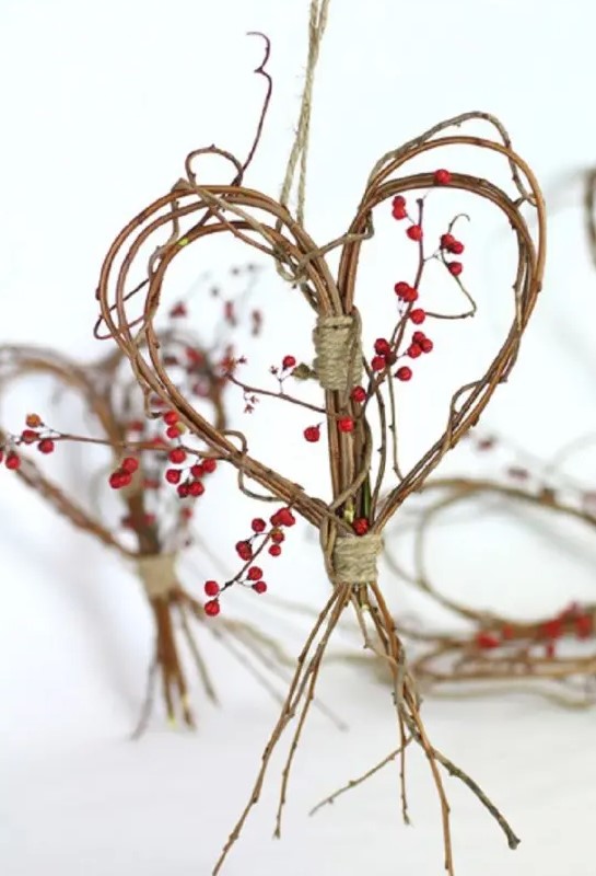a branch and twig heart wreath with berries and twine is a cool fall decoration to go for