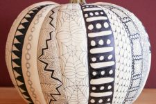a cathcy black and white pumpkin decorated with a sharpie for Halloween is a super cool idea