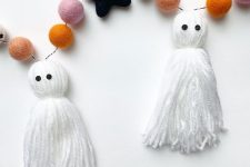 a chic Halloween garland with tassel ghosts and colorful felt balls plus black stars is amazing for Halloween decor