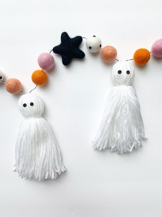 a chic Halloween garland with tassel ghosts and colorful felt balls plus black stars is amazing for Halloween decor
