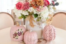 a chic and bright fall flower arrangement of white, pink, rust blooms and greenery and pink faux pumpkins