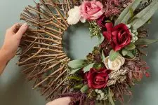 a chic fall wreath of twigs and sticks, greenery and blooms is a beautiful decoration to DIY
