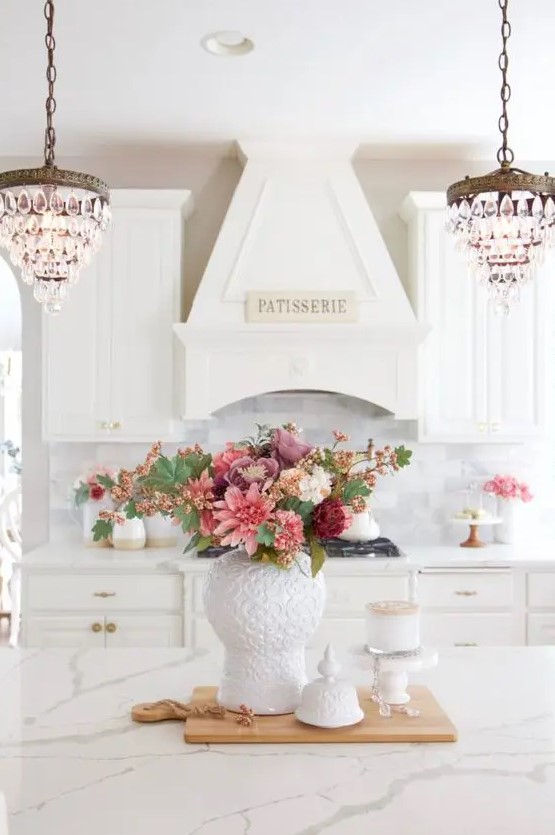 a chic monochromatic floral centerpiece of pink, dusty pink, burgundy and white blooms and greenery for the fall