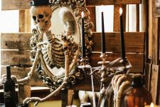 a chic vintage mirror with a glitter and sequin skeleton in a top hat is a cool vintage decoration for Halloween
