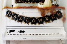 a classic Halloween banner with burlap pieces and black paper ones with letters is a lovely idea for a Halloween space