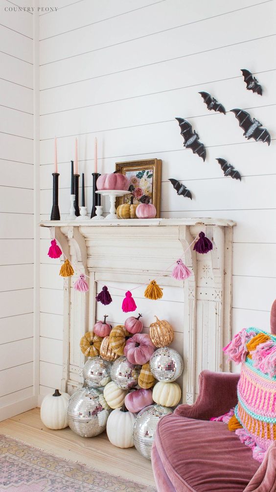 a colorful tassel ghost garland will be great for bright Halloween decor, add colorul pumpkins and candles