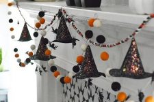 a cool Halloween garland of felt balls in white, orange and black and shiny witches’ hats is a great idea to rock