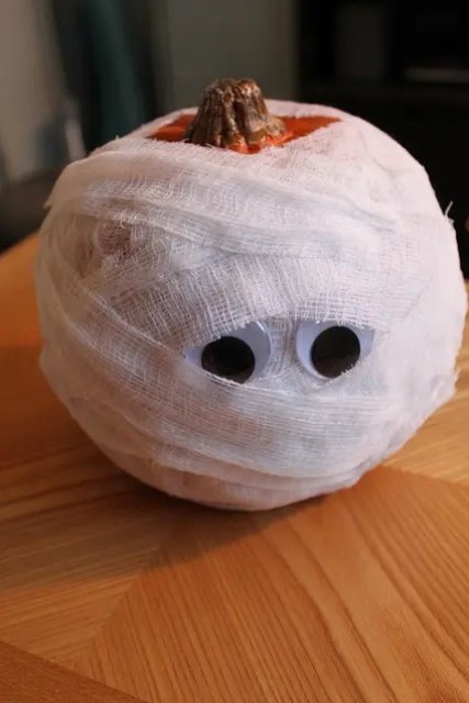 a cool mummy pumpkin with googly eyes is a lovely decoration for Halloween that you cna make with your kids