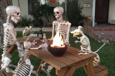 a cool outdoor bbq scene done with skeletons and skeleton dogs plus jack-o-lanterns is a very fresh and fun idea