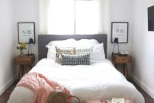 a cozy small bedroom with stained nightstands, a bed with neutral bedding, a bench, some pink blankets and pillows