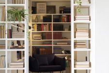 a doorway finished off with built-in bookshelves that double as space dividers and provide a lot of book storage space