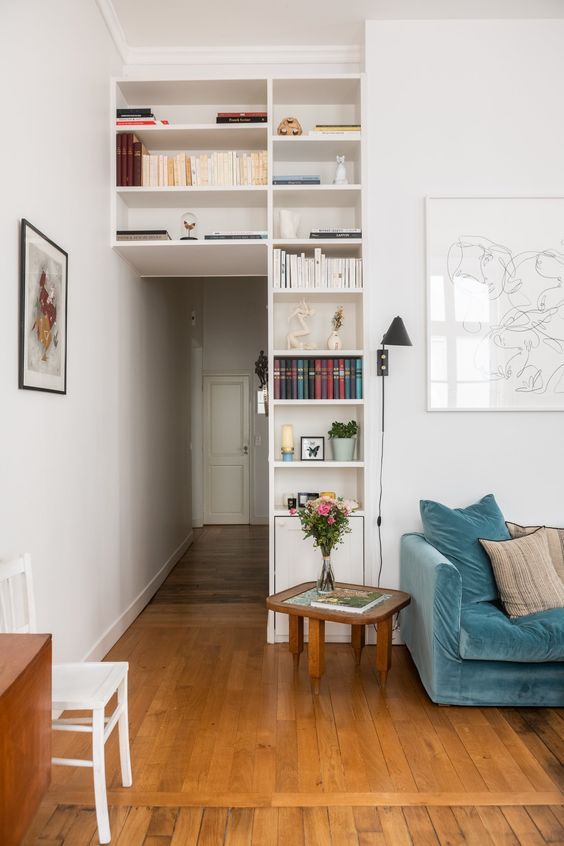 a doorway surrounded with open shelves to store and display stuff is a smart solution for saving space