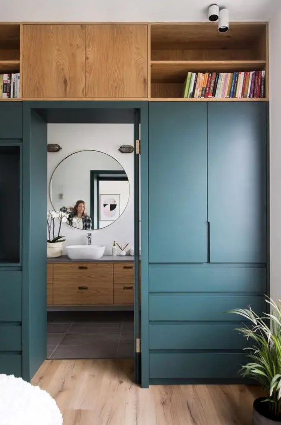 a doorway wall covered with sleek cabinets and drawers, open shelves will let you store a lot of things and not clutter the bedroom