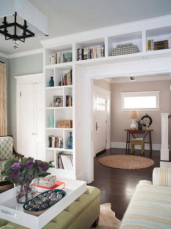 a doorway with built in shelves is a cool idea to store books and various decor, display them at their best and not to sacrifice any floor space