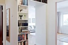 a doorway with niche bookshelves is a very smart solution to store your books, add a catchy touch to the space and separate the units