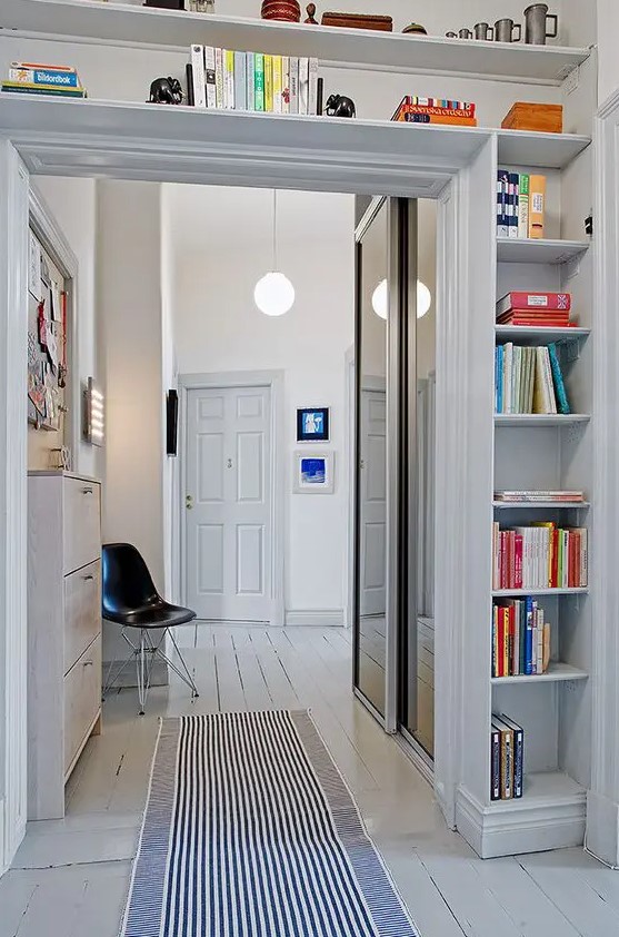 a doorway with open shelves covering the whole space over it is a cool idea to store some things and use the unused space