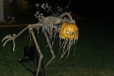 a freaky and scary Halloween figure with a pumpkin head will scare everyone and will make your yard bold