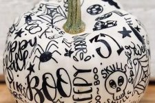 a fun contrasting pumpkin in white, decorated with a black sharpie, can be a nice idea for a modern Halloween party or just as decor