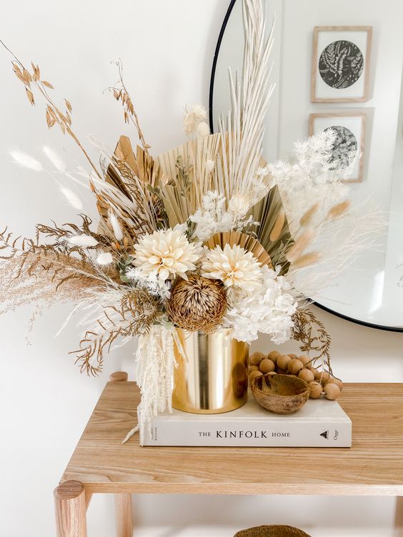 a gorgeous dried and faux flower arrangement with fronds, grasses and amaranthus done in neutrals