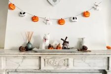 a lovely 3D Halloween garland with pumpkins, Jack Skellington faces and little ghost dogs is a stylish and cool idea for Halloween