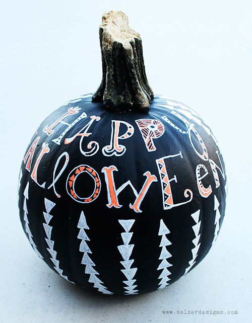 a lovely boho Halloween pumpkin in black with orange letters and white triangles is wow