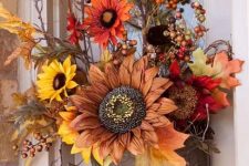 a lovely fall faux flower arrangement with leaves, berries and twigs in traditional fall colors will substitute a usual wreath