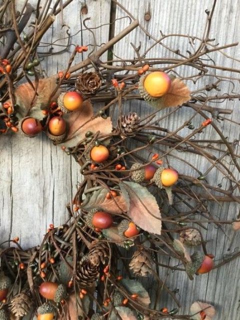 a lovely fall wreath of twigs, berries, acorns and leaves plus pinecones is great for fall and Halloween decor