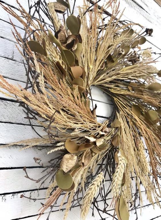 a lush fall wreath with grasses, leaves and twigs will be great for rustic or boho outdoor decor, it looks nice