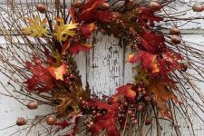 a lush twig fall wreath with bright faux leaves, acorns and berries will bring much color to the porch