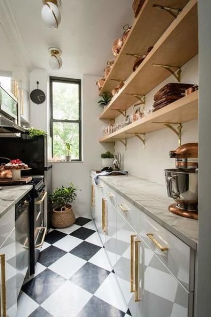 a modern narrow kitchen with sleek white cabinets and stone countertops, open shelves, potted greenery and a checked floor