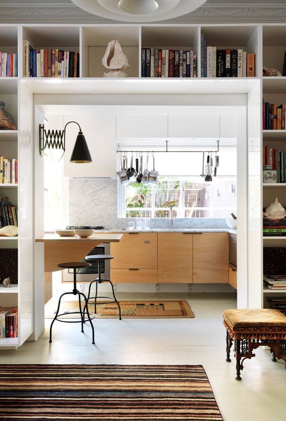 a modern space with a doorway finished off with open storage shelves that are used for displaying and storage