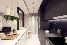 a narrow black and white kitchen with sleek cabinets, built-in lights and pendant lamps, potted herbs