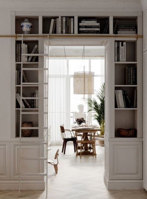 a neutral storage unit with open storage compartments over the doorway is a cool solution that saves the space