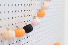 a pretty Halloween pumpkin garland of mini pumpkins in various colors will match both fall and Halloween decor