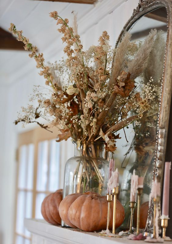 a pretty and cool dried flower arrangement with lots of leaves and grasses is a cool idea for boho or rustic fall decor