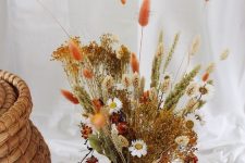 a pretty bright dried flower arrangement with some grasses of various colors is a cool idea for fall or Thanksgiving