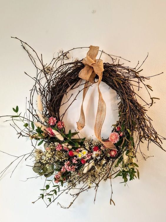 a pretty fall wreath of vine and twigs, dried flowers and leaves and a burlap bow on top is a super cool idea for the fall