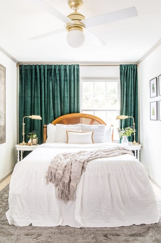 a refined small bedroom with a bed with a can headboard and neutral bedding, elegant nightstands and lamps and amazing green curtains