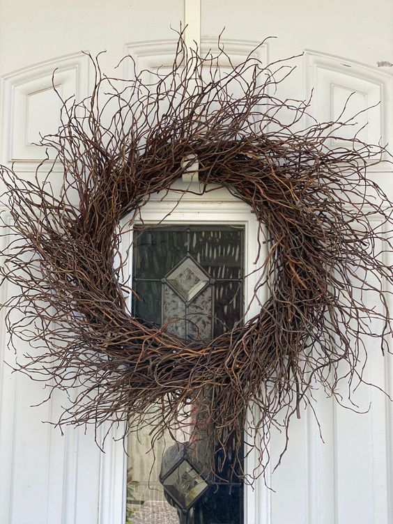 a rustic twig wreath with no details will be a great idea for both fall and Halloween, it looks nice and relaxed