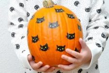 a simple and classic black cat pumpkin decorated with a usual sharpie will be a nice idea to craft with your kids