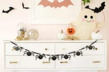 a simple black spider banner is a cool and fast to make idea for Halloween, it will make your space cooler