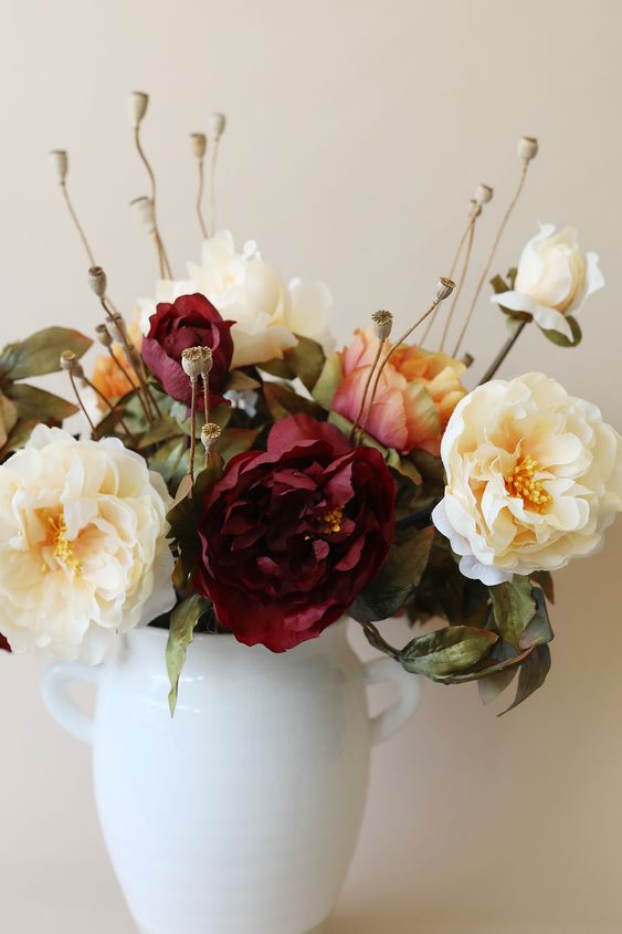a simple faux fall flower arrangement in neutrals and burgundy is a lovely idea, it will add elegance to the space