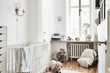 a small Scandinavian nursery with a white crib, a gallery wall, a windowsill with decor, toys and a dresser