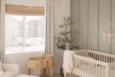 a cozy nursery with an olive green accent wall